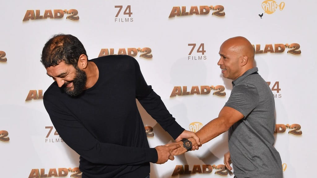 Ramzy Bedia pulling Eric Judor at the premiere of Alad'2 at Le Grand Rex